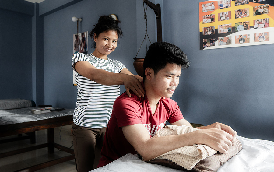 Ms. Parbati performing head & shoulder massage to the assistant trainer. Where is assures the thumb pressure and palm movements.